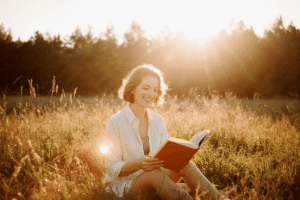 JOMO in action – peaceful reading at sunset Embrace Your Mental Limits – woman reading a book in nature during golden hour, peaceful and calm